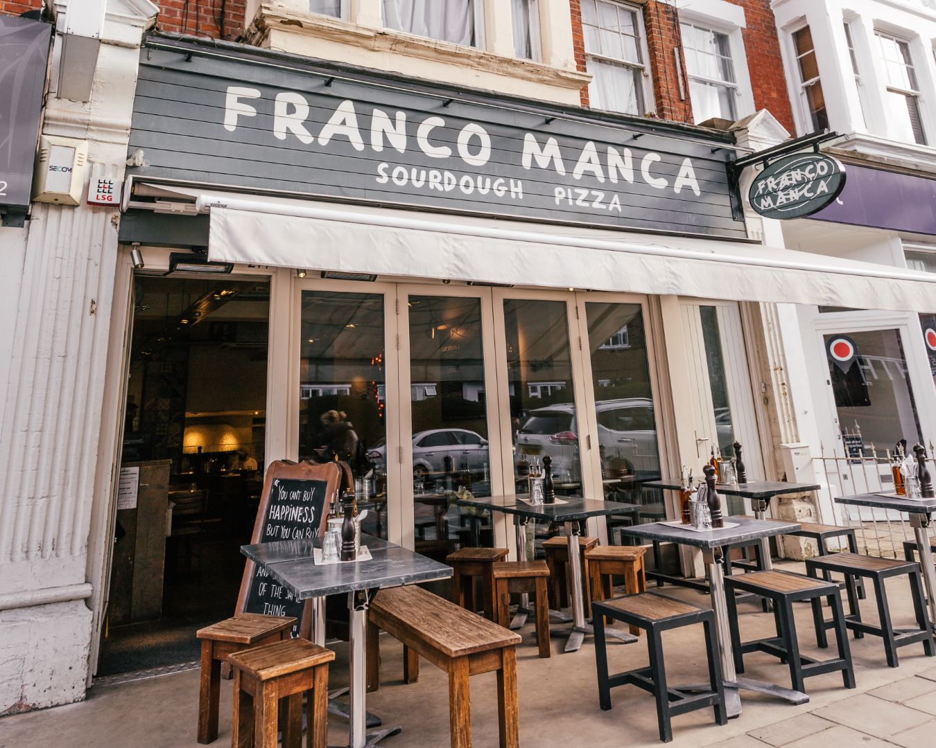 outside Franco Manca tables in Southfields